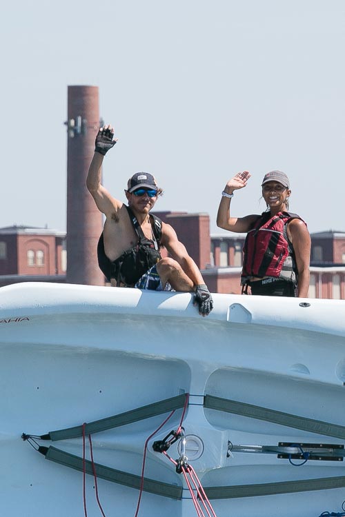Instructors waving on a capsized Bahia