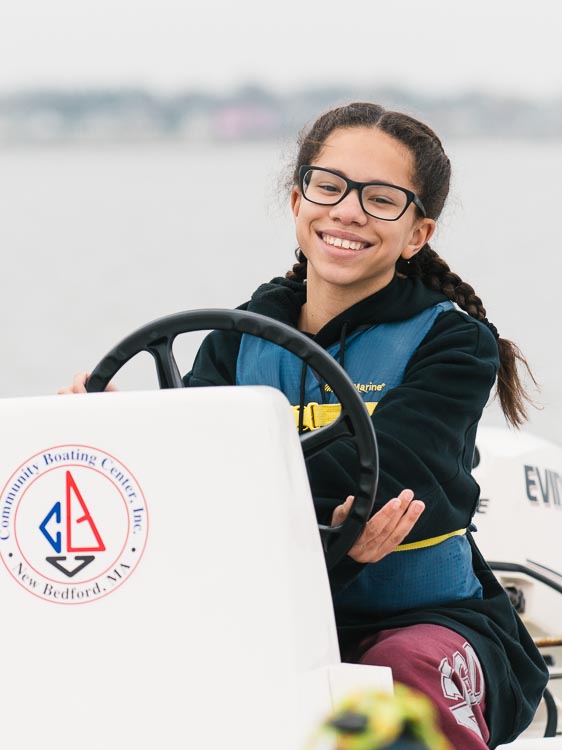 student driving a motor boat