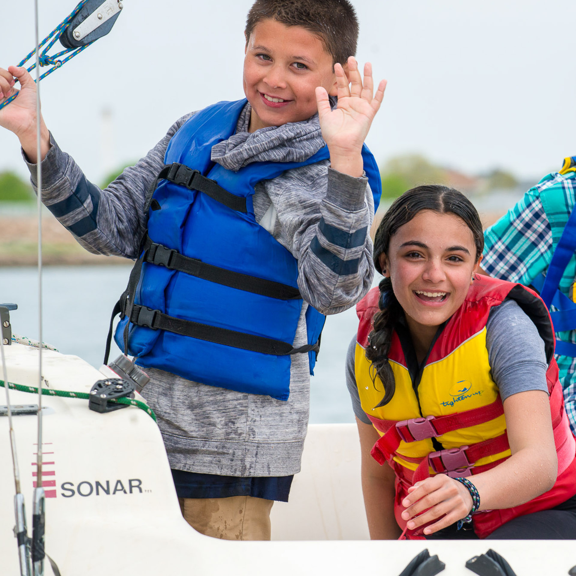 Student waving on a sonar