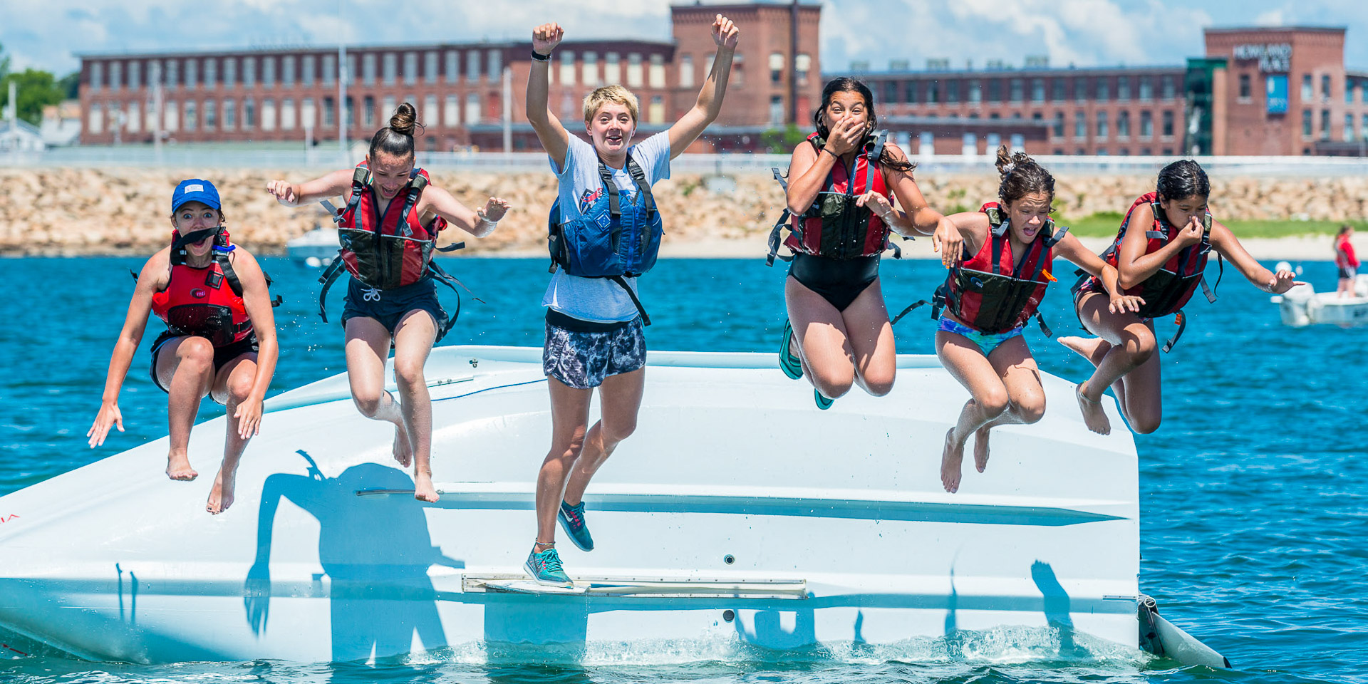 Students jumping off the side of capsized bahia