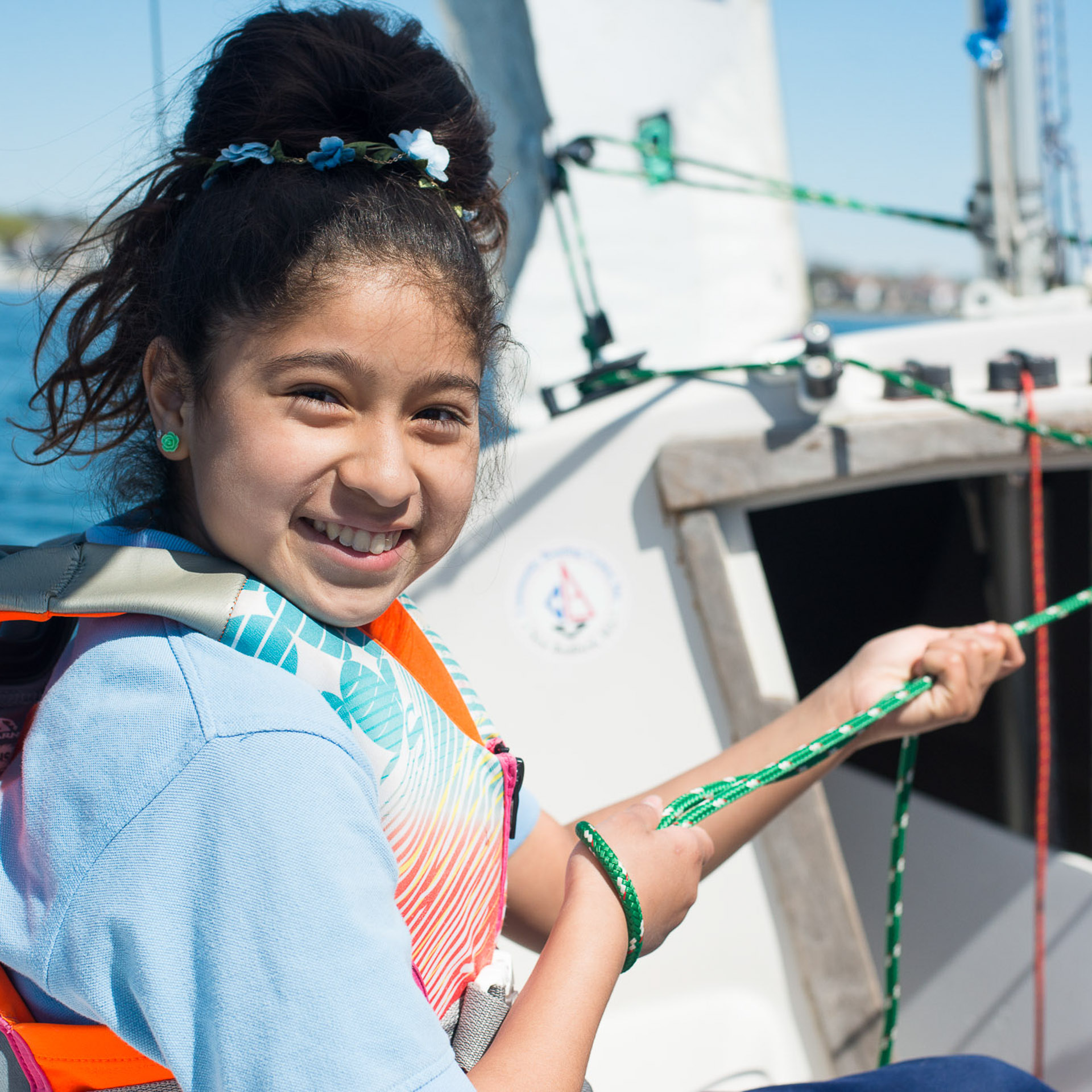 Student pulling in a jib on sonar