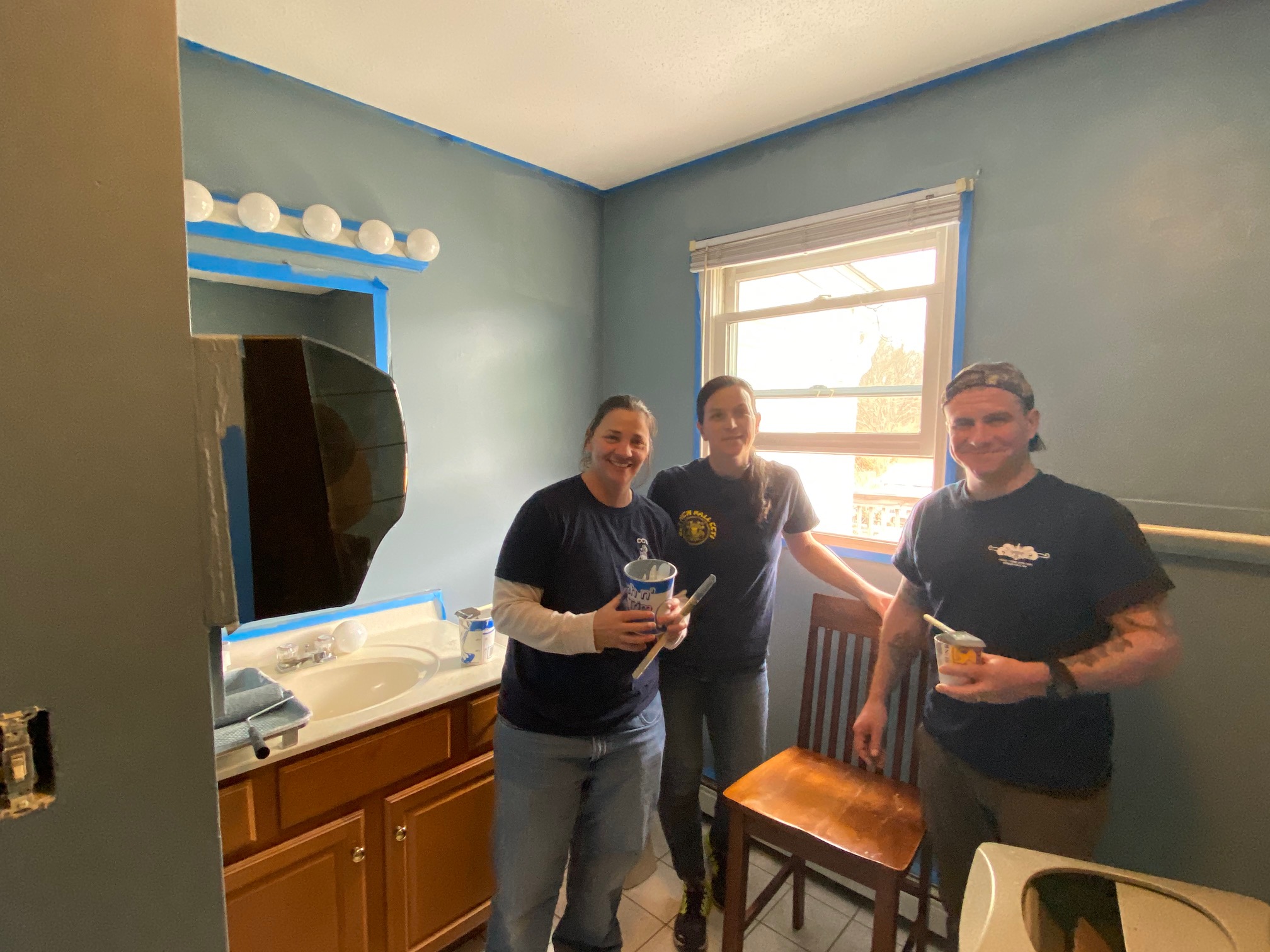 Volunteers painting the bathroom at CBC