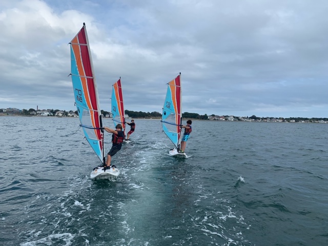fleet of windsurfers sailing together