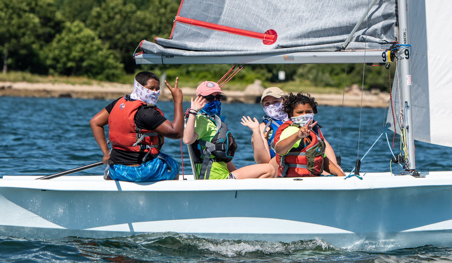 Kids sailing Bahia with masks on