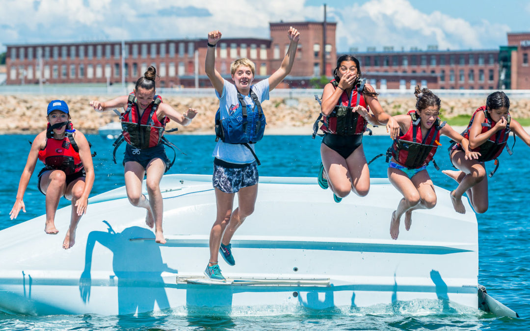 Students jumping off the side of capsized bahia